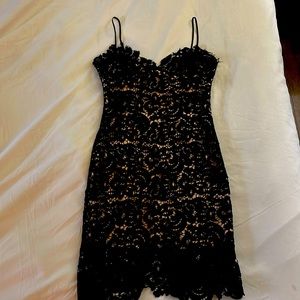 Sophisticated and stunning lace dress with nude lining size Small.